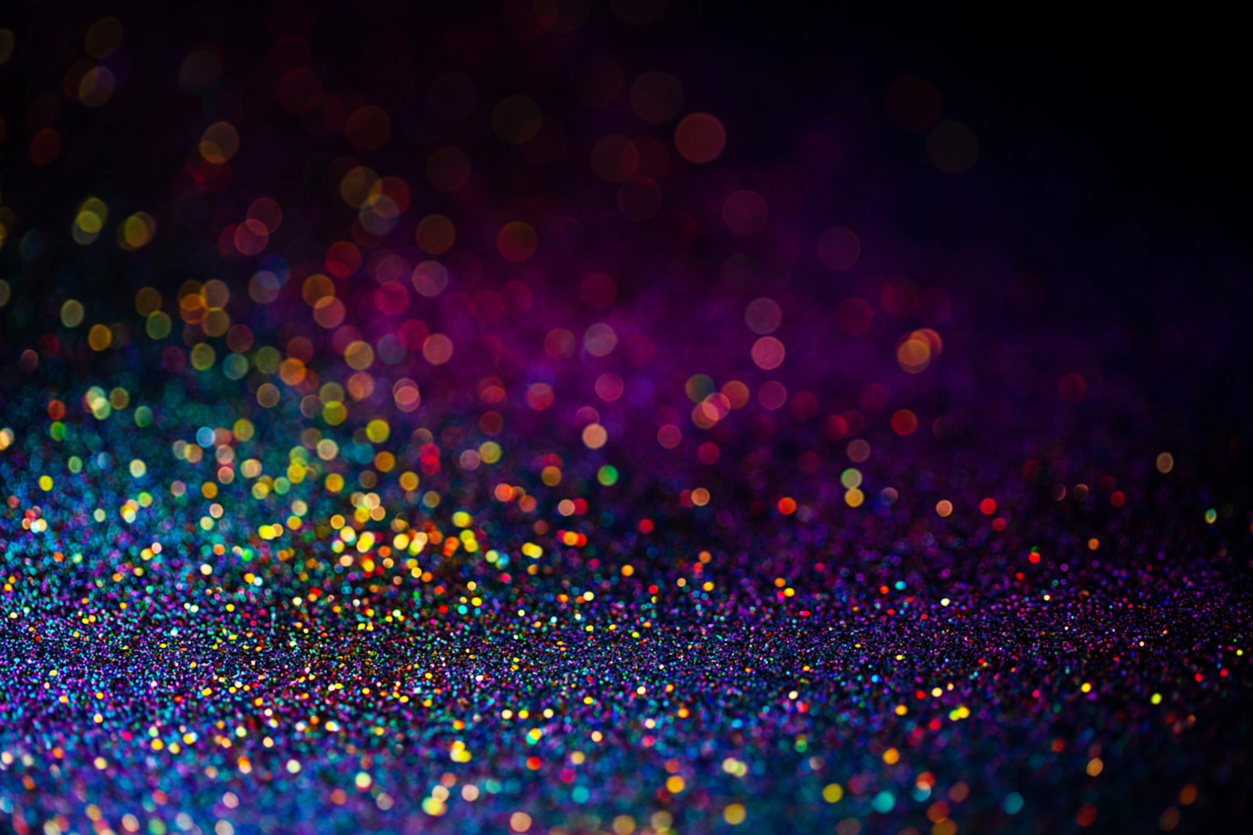 Shiny multicolor glitter background. Abstract shimmering pink, blue, yellow circles as a decorative backdrop.
